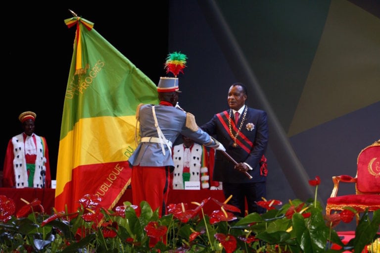 Congolese President Denis Sassou Nguesso (R) receives from a soldier the flag of the Republic of Congo during his inauguration ceremony, in Brazzaville, 16 April 2016, GUY-GERVAIS KITINA/AFP via Getty Images
