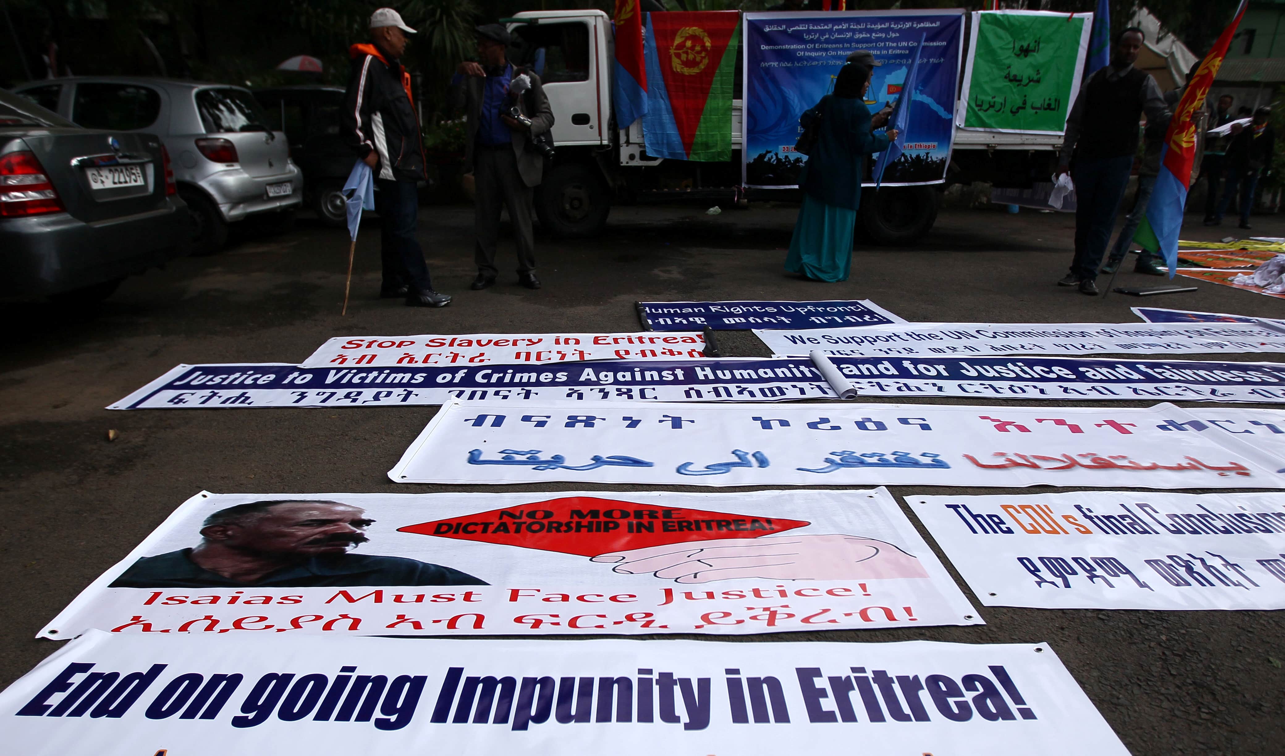 Eritrean refugees display banners and placards with pictures of Eritrean President Isaias Afwerki during a demonstration in support of a U.N. human rights report accusing Eritrean leaders of crimes against humanity in front of the Africa Union headquarters in Addis Ababa, Ethiopia, 23 June 2016, REUTERS/Tiksa Negeri