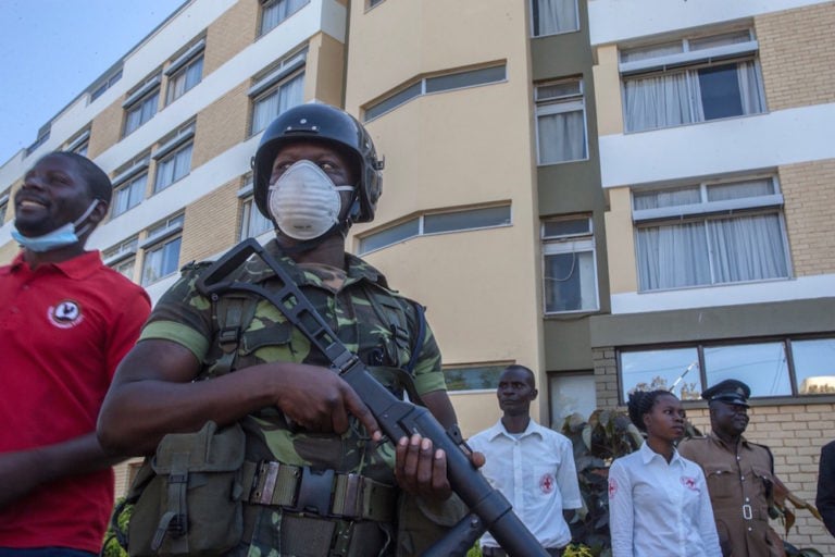 An armed police officer wears a face mask as a preventive measure against the spread of COVID-19, in Blantyre, Malawi, 6 May 2020, AMOS GUMULIRA/AFP via Getty Images